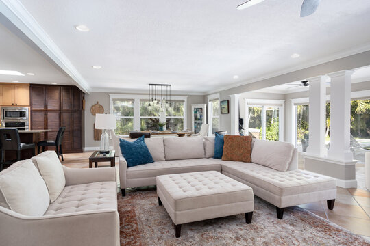 Vacation rental home with large white sofa in open living and dining area