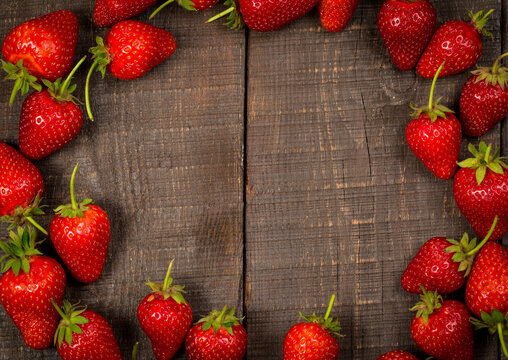 Fresh red strawberries on a wooden table, strawberries for dessert
