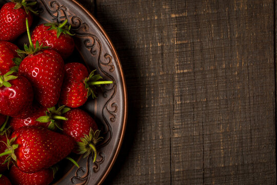 Fresh red strawberries on a wooden table, strawberries for dessert
