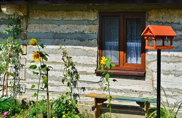 Fototapeta na wymiar View on a window and front wall of an old wooden house, seen on a Hanczowa village, Low Beskids, Poland