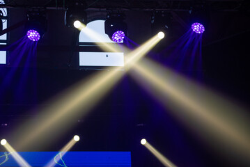 Fototapeta na wymiar concert stage. bright colorful lighting beams on dark background