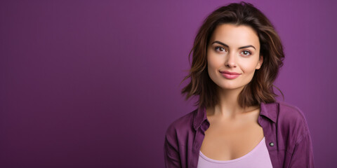 Young woman over purple wall smiling