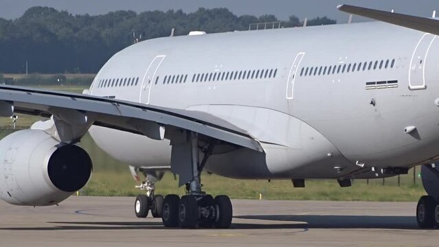 Military Tanker and Transport Aircraft Taxiing left to right at Air Base