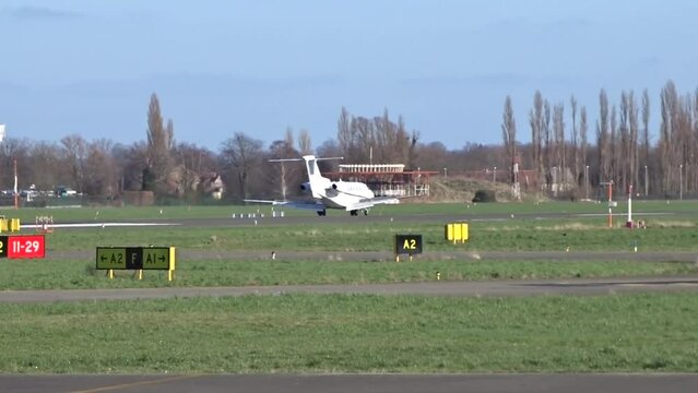 Business jet Landing with Touch Down at Airport (Corporate Executive Private Jet Touching down at Airfield)