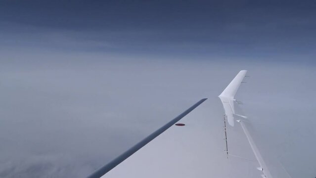 Airplane Wing view Outside clouds sky business jet aircraft