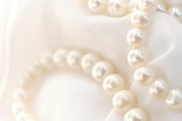 Fototapeta na wymiar Pearls lay scattered on a white canvas, their natural glow a soft whisper of elegance. The image contrasts the loud demands of modern trends, urging a return to the simple and authentic.