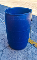 Blue trash garbage cans dirty street Playa del Carmen Mexico.