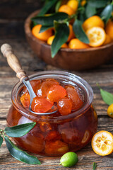 Homemade kumquat jam in jar and fresh kumquats