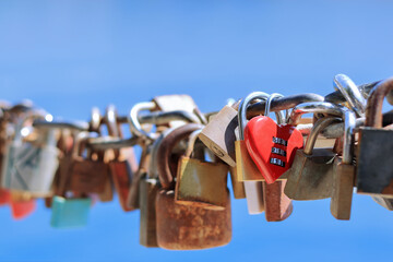 Red heart shaped padlock. Makarska Croatia. Line of Love padlocks hanging on a chain. Love locks....