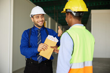 boss or manager giving money to worker for jobs in the factory