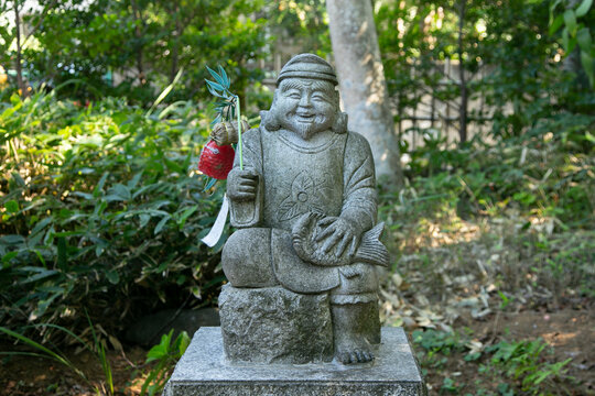 Statue of a monk at a Shinto shrine in the city of Sakura in Japan.
