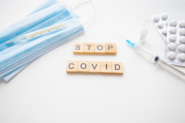 Stop coronavirus inscription. Preparing for vaccination against covid-19. Syringe, vaccine, pills,...