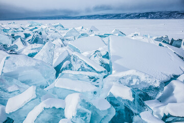 Fototapeta na wymiar Breaking freezing water Baikal lake in winter season. Natural landscape background
