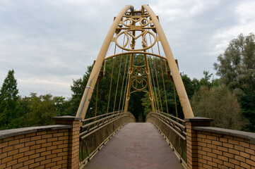Footbridge connecting parts of the historic dike (Bierunska grobla). Bierun, Poland. - obrazy, fototapety, plakaty