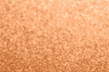 Abstract defocused glitter texture, background. Color of the year 2024 - Peach Fuzz. Copy space