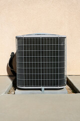 An outdoor air conditioning condenser unit near house.