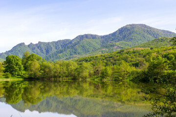 Fototapeta na wymiar mountainous terrain, natural lakes in the morning light, spring nature walks, panorama of the area.