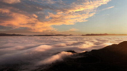 Fototapeta na wymiar Overlooking the fog-filled Elsinore Valley at sunrise in southern California