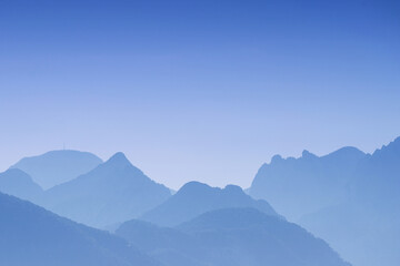 Fototapeta premium Abstract blue mountains and colorful sky - turquoise sunset over the landscape - background