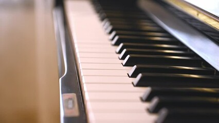 Overhead closeup view of black and white keys, ivory and ebony keyboard of classical wooden piano. Chord musical instrument. Music. Arts, culture and entertainment. Still life