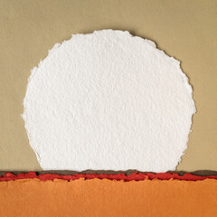 moon or sun rising over abstract colorful landscape, blank circular watercolor paper
