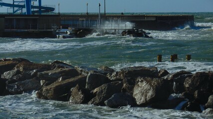 Rough blue mediterranean sea and rocks from the bay of Livorno