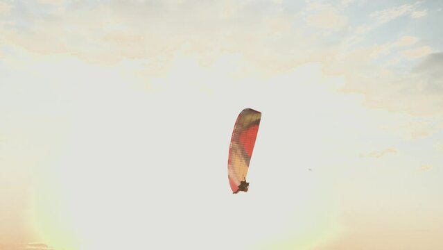 Hot air balloons and paragliders flying during a beautiful sunrise in the Serra da Canastra mountains in Minas Gerais, southeastern state of Brazil