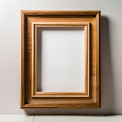 Empty wooden picture frame with clipping path isolated over white wall; free space for text