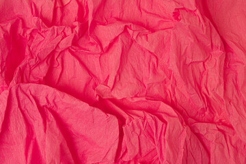 Crumpled paper background. Pastel red.
