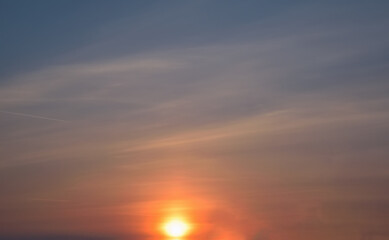 Naklejka na ściany i meble Beautiful sky background - Sunset Sunrise sky with light clouds and real sun.