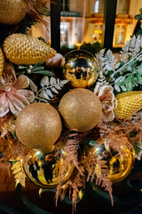 Christmas and New Year street decoration, round Christmas wreath hanging on metal gates, illuminated glass door at night, Epernay, Champagne, France