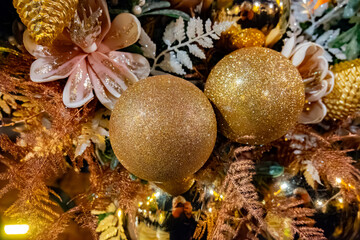 Christmas and New Year street decoration, round Christmas wreath hanging on metal gates, illuminated glass door at night, Epernay, Champagne, France