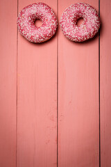 Sweet pink donuts on a pink background