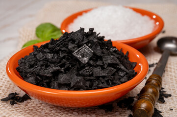Black and white sea salt close up, Cyprus Black Salt shiny black pyramid-shaped crystals