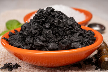 Black and white sea salt close up, Cyprus Black Salt shiny black pyramid-shaped crystals