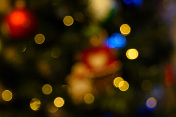Blurred out-of-focus bright lights of a garland on a dark background close-up