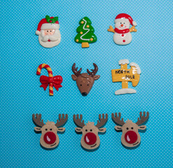 Christmas composition consisting of toys Santa Claus, reindeer, snowman, Christmas tree, and deer. Flat lay. New Year minimal concept.