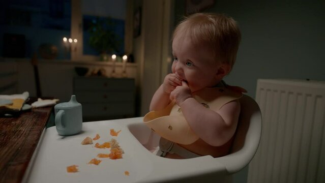 Adorable Toddler Eating In Kitchen