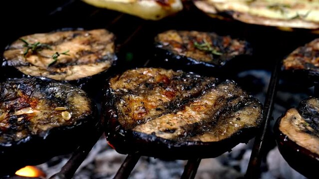 Grilled eggplant ring preparing on barbecue grill.