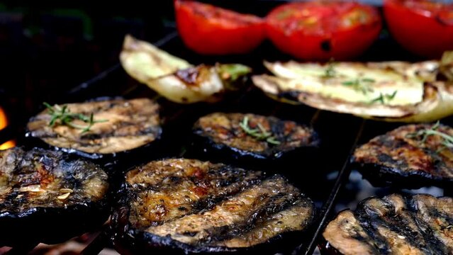 Grilled eggplant ring preparing on barbecue grill.
