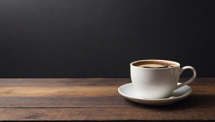 Coffee cup on dark wooden table over black background with copy space