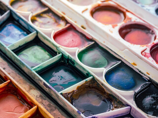 palette with watercolor paints close-up, macro, colorful background of the artist's palette,...