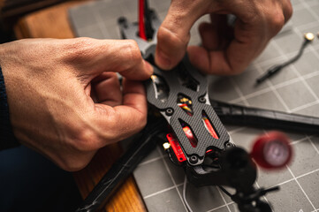 soldering, assembling, IC part of fpv drone esc part assembled by man. Close-up view, high...