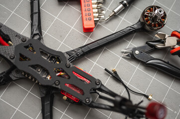 soldering, assembly, spare parts fpv drone esc part assembled by man in workshop. Close-up, high...