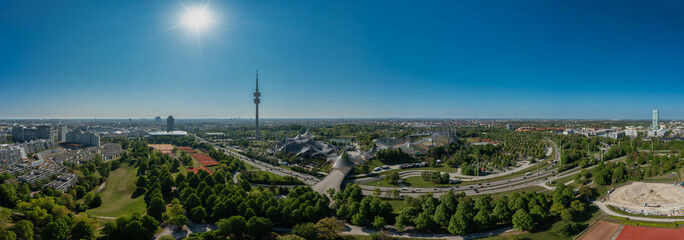 Sunny panoramic view of Munich's Olympic Park with sunshine.