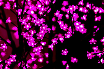 Flower-shaped lights for decoration. Christmas tree. New Year’s Day.