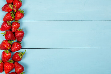 Fresh red strawberries on a blue background, background with strawberries