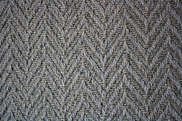Texture of rustic herringbone fabric in shades of grey. Decorative background
