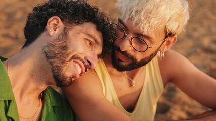 Romantic moments, homosexual couple enjoying intercourse with each other while sitting on the beach...