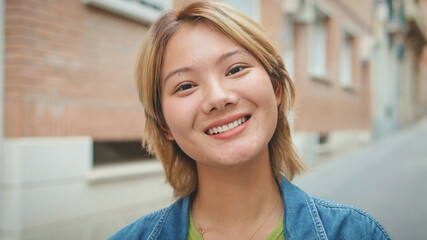 Close-up of young smiling woman looking at the camera